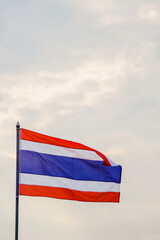 Motion and blur, the Thai flag fluttering atop the flagpole represents the Thai nation that knows love and unity. The colors of the Thai flag represent the nation, religion, and the king.