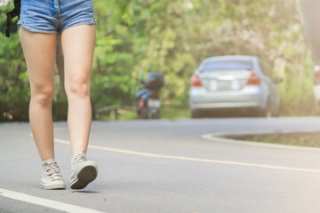 Soft Light And Smooth Focus,An Asian woman is traveling alone on her intended path after being confined to the house during a virus outbreak. Young women walking down the road to travel in the summer