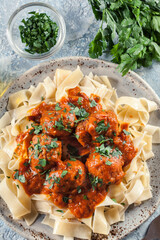 Meatballs with tomato sauce served with pappardelle pasta