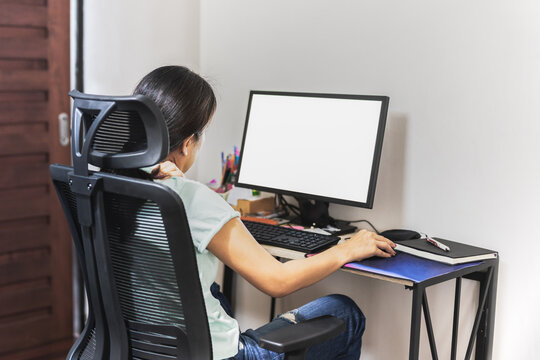 Tired fatigued woman working on compuetr and massaging stiff neck on shoulder.