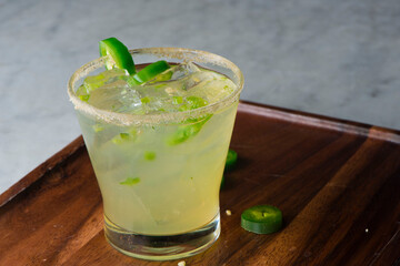 Margarita. Classic traditional Mexican cocktail. Made with Blanco tequila, fresh lime juice, agave syrup and orange juice. Served in salt rimmed tumbler over ice and garnished with a lime.