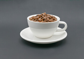 ROASTED COFFEE BEANS IN A COFFE CUP