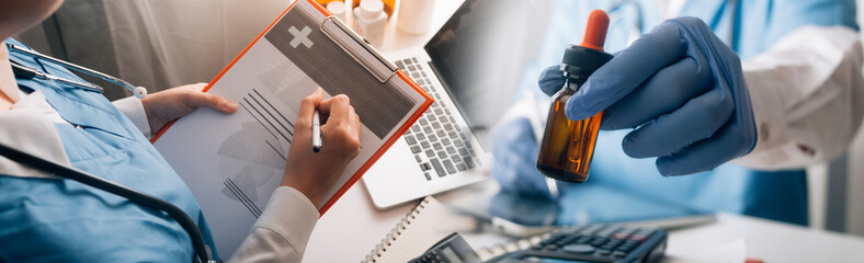 Health care researchers working in life science laboratory and analyzing microscope slides in...