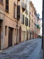 Ferrara, Italy. Old town, sunny medieval street, without people.