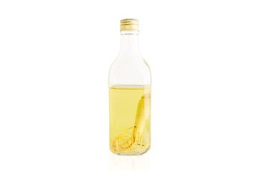 Ginseng roots in the glass bottle isolated in white background.