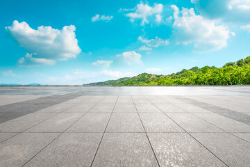 Empty square floor and green mountain landscape.