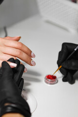 woman applying nail polish on her lips, hand with nail polish, nail polish, red blood drop, red, hand, beauty, beauty industri, nails, beauty nails