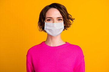 Portrait of nice girl look in camera wear white face mask isolated over bright yellow color background
