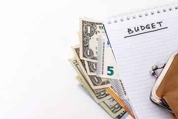 Planning financial expenses. Notepad with word BUDGET, money, purse.
