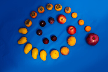 the above view of a spiral line of the fruits over the blue background