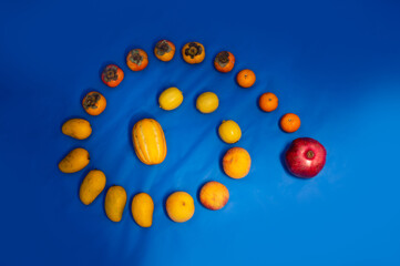 the swirl line of the different fruit over the dark blue background