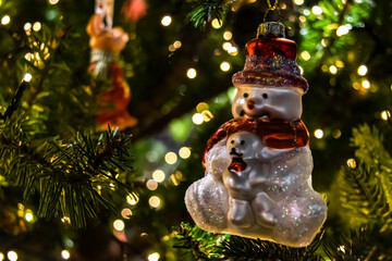 Christmas tree with vintage decorations and sparkling evening festive lights, soft warm colors.