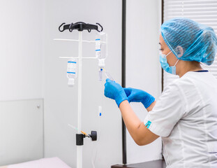 Doctor prepares the system with a dropper and a solution