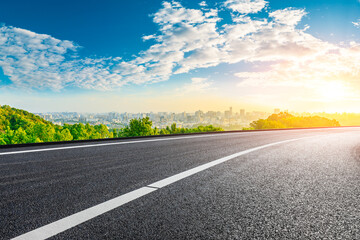 Fototapeta premium Asphalt road and city skyline with buildings in Hangzhou at sunrise.