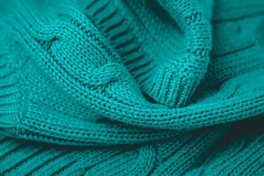 Teal green color background. Full frame shot of knitted fabric