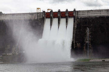 Water flowing over floodgates of a dam at Khun Dan Prakan Chon, Nakhon Nayok Province, Thailand
