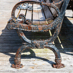 rusted and weathered cast iron bench on the Atlantic City New Jersey boardwalk