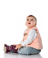 Amazed baby girl looking up studio shot on white