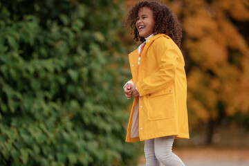 Adorable little girl outdoors at beautiful autumn day