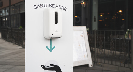 A pandemic hand sanitiser dispenser in a shopping centre