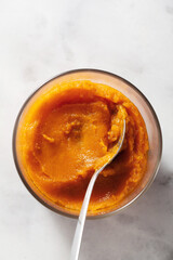 baked pumpkin puree in a glass bowl on a marble table