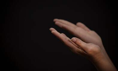 Woman's hand praying and worship to GOD Using hands to pray in religious beliefs and worship christian in the church or in general locations in vintage color tone or copy space.