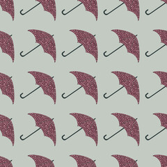 Seamless pale pattern with maroon dotted umbrella shapes. Simple season print on grey background.