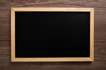 blank blackboard on wooden background