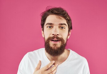 Cute guy with beard on pink background close-up portrait cropped view