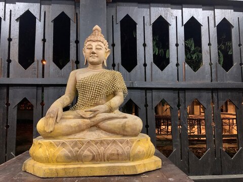 A focus image of wooden Buddha in the temple