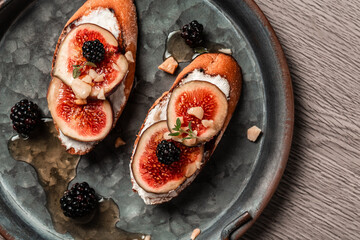 Toasted figs, ricotta cream cheese, thyme, honey. Healthy food concept. space for text. Top view