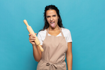 young caucasic woman with cheerful, carefree, rebellious attitude, joking and sticking tongue out,...