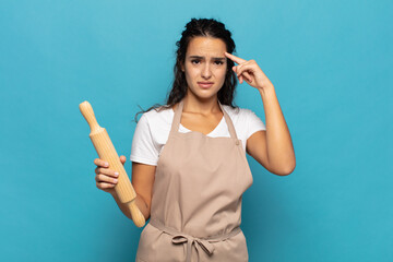 young caucasic woman feeling confused and puzzled, showing you are insane, crazy or out of your mind