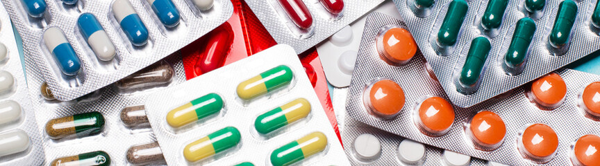 Pharmaceuticals, antibiotics, pills, medicines. Close-up of colorful antibacterial pills. Banner on a medical theme. Medical concept