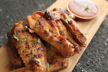 Delicious chicken wings, baked or fried chicken wings served with hot spicy  barbeque sauce