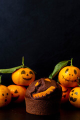 Chocolate and mandarin halloween muffin on a dark background