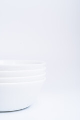 Blurry image of three small white bowls isolated on white background include clipping path
