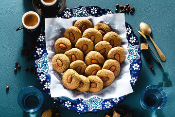 turkish cookies with almonds and coffee on the table in