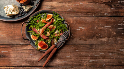 Prosciutto salad with figs and blue cheese. Food for wine