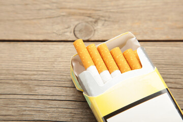 Pack of cigarettes on grey wooden background. No smoking.