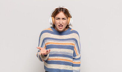 young blonde woman looking angry, annoyed and frustrated screaming wtf or what’s wrong with you