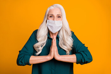 Photo of pretty lady holding hands together excited beg wear mask green shirt isolated bright...