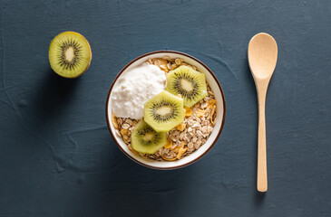 Cereal bowl with kiwi and yogurt, top view