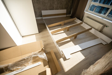 assembly of a double bed made of wood and lamella