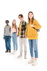 Positive multiethnic teenagers with backpacks holding hands and looking at camera on white background