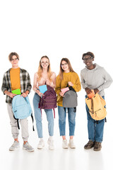 Obraz premium Cheerful multicultural teenagers with books and backpacks looking at camera on white background