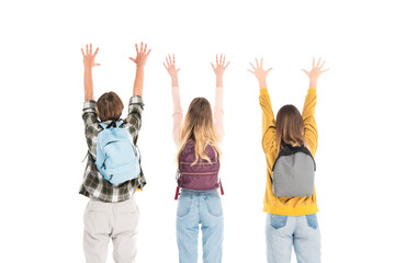 Fototapeta premium Back view of teenagers with backpacks and raised hands isolated on white