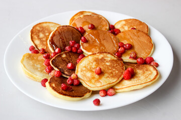 Mini pancakes with fruit drizzled with chocolate and honey