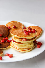 Mini pancakes with fruit drizzled with chocolate and honey