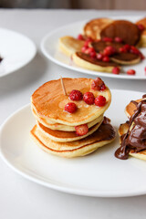 Mini pancakes with fruit drizzled with chocolate and honey